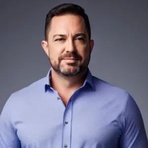 a man in a blue shirt posing for a photo.